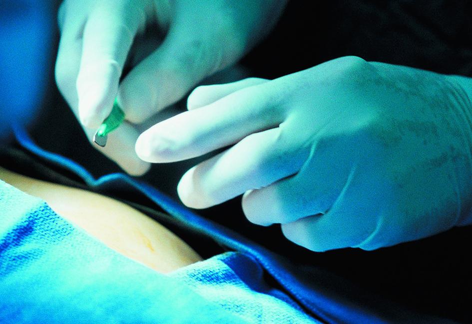 Close up teaser image of hands holding a scalpel, used in facility marketing brochure designed by Carolyn Porter of Porterfolio, Inc. for Boston Scientific's medical education team